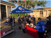 Police and residents mingle near a Victoria Police Department booth in the City Hall courtyard.