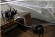 Two spiders made from pumpkins and black sticks with faux cobwebs