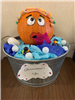 Pumpkin woman sitting in a tub with fake water and bubbles made of golf balls