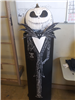 Jack Skellington figure with pumpkin head. Sign reads, 