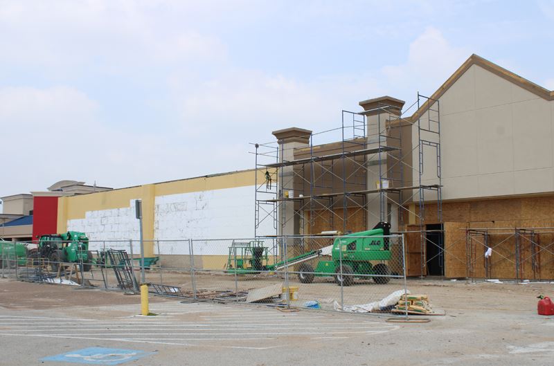 Construction on the facade at the former Sears space. Includes scaffolding and chain link fences.