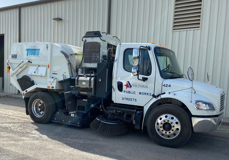 A street sweeper with the City of Victoria Public Works logo