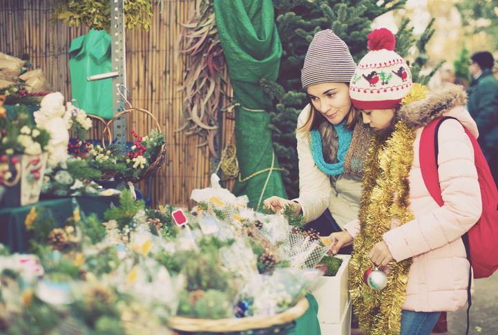 A woman and a child browse holiday decorations