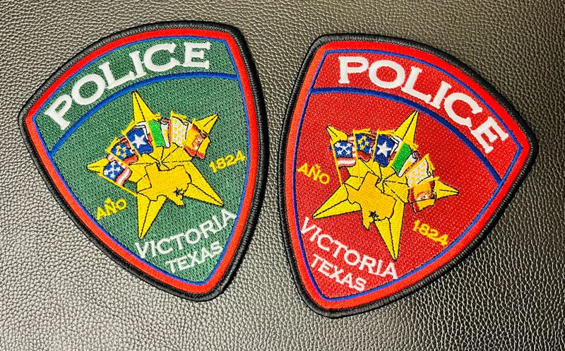 Two Victoria Police Department patches. One is green and one is red
