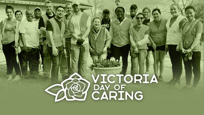 Victoria Day of Caring. Group photo of volunteers at a neighborhood cleanup.