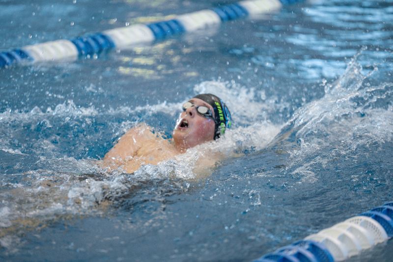 Swimmer doing a backstroke in a pool