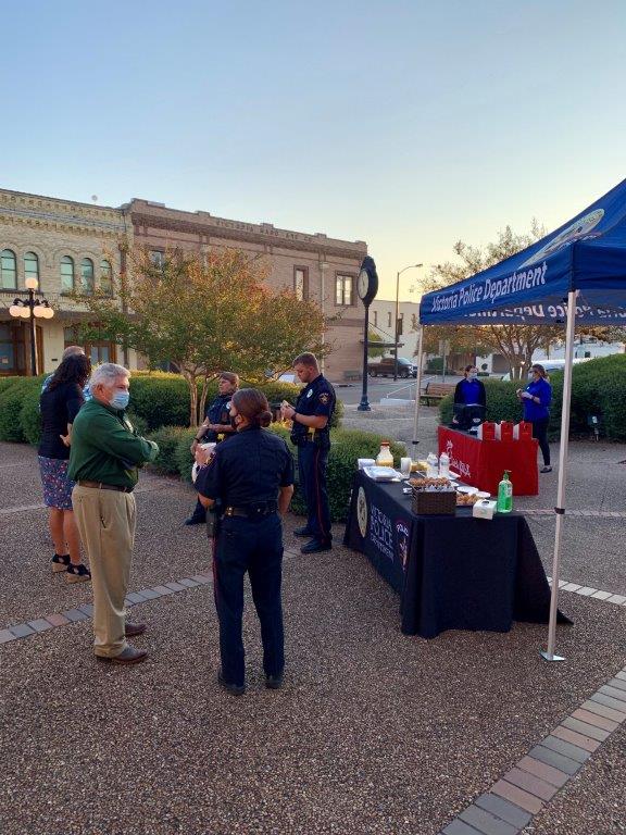 Police and residents mingle near a Victoria Police Department booth in the City Hall courtyard.