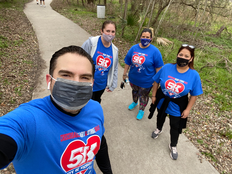 Jesús Garza and 3 City employees on walking trail in Riverside Park wearing masks & matching shirts