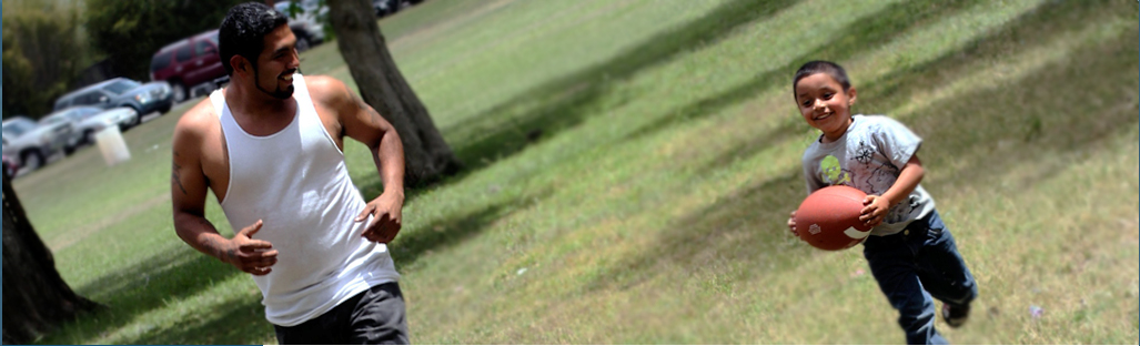 Man and Kid Playing Football