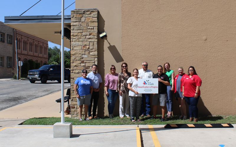 Group photo outside Christ's Kitchen with KVB beautification grant sign