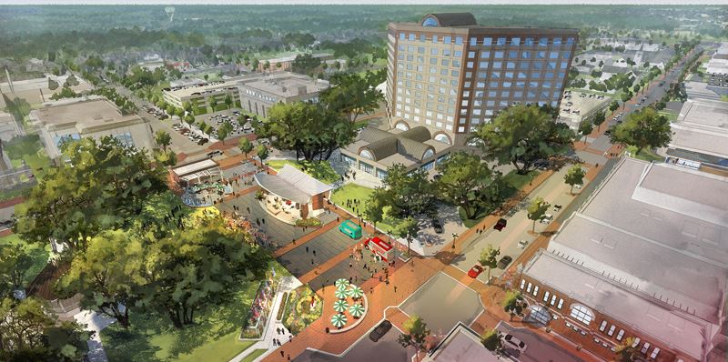Aerial view of DeLeon Plaza expansion with a stage, food trucks and umbrella tables