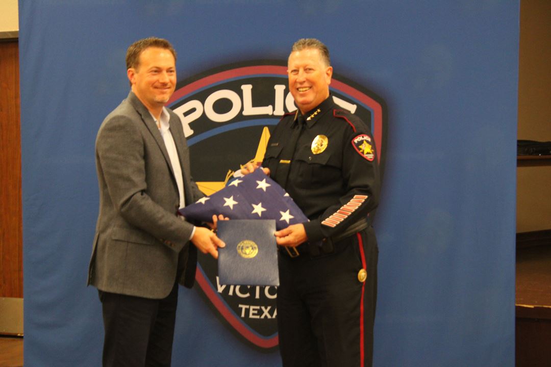 U.S. Representative Michael Cloud presents Victoria Police Department Chief J.J. Craig with an Ameri