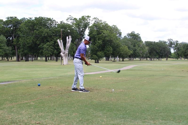 Man prepares to tee off at golf course