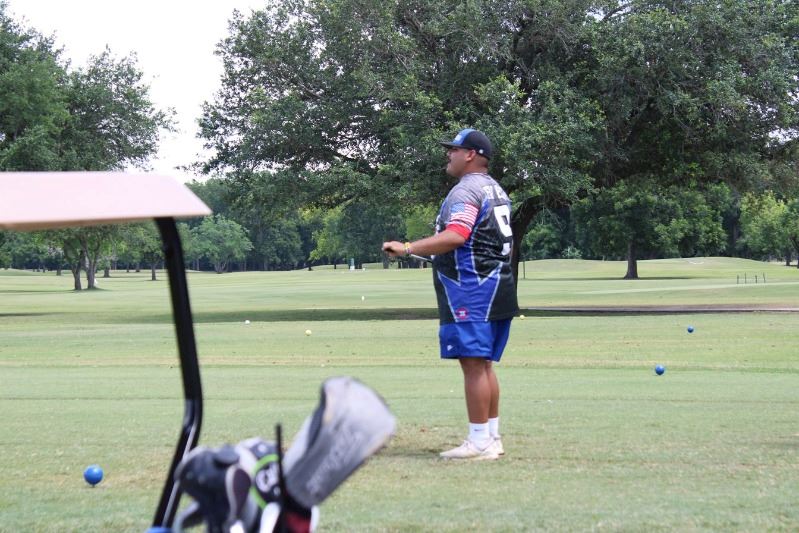 Man watching his shot in the distance on golf course
