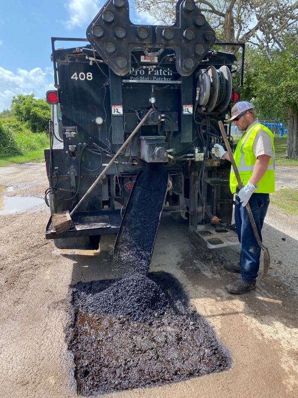 James Toth repairs a pothole using one of the City of Victoria’s patch trucks.