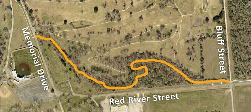 A map shows a winding path through a wooded area adjacent to the golf course.