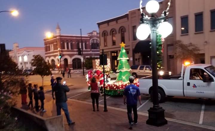 Truck pulls lighted parade float featuring lighted blowup Christmas tree