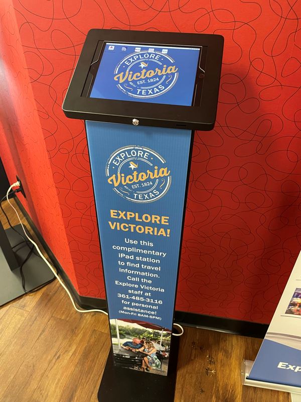 iPad station. Text reads, Call the Explore Victoria staff at 361-485-3116 for personal assistance.